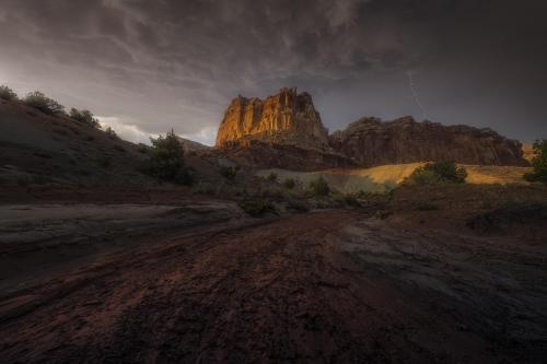 A stormy afternoon over a dried flood wash and sandstone cliffs. Capitol Reef, Utah