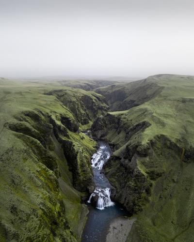 Waterfall in a green canyon, southern Iceland