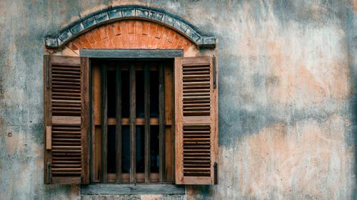Old cement wall with wood window