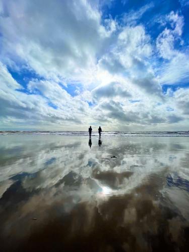 Charnmouth, Dorset.  On the south coast of England. A thin layer of sea water stays up on the beach at low tide. My kids enjoying chasing the waves!