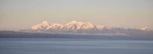 Illampu is the fourth highest mountain in Bolivia at 6,356 meters  above sea level. Seen here from Isla del Sol looking across Lake Titicaca.