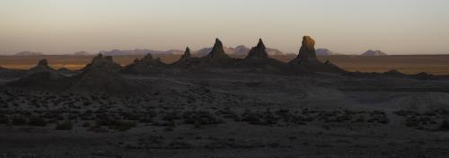 The Trona Pinnacles against the warm sunset-lit desert, California