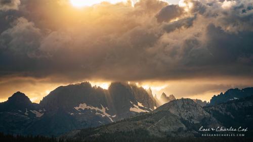 Sunshafts shining through the gaps of storm clouds and the Sierra Nevada craggy peaks in California