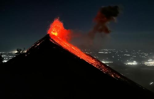 Volcan de Fuego erupting against the backdrop of many surrounding villages and towns