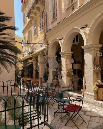 Visit Old Corfu Town in Corfu Greece &amp; Palazzino Veneziano. Enjoying a traditional coffee in the narrow streets of the old town of Corfu