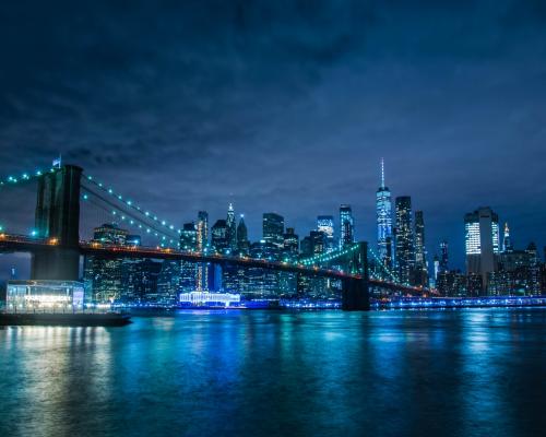 City Skyline Across Body of Water during Night Time